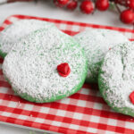 Crispy green sugar cookies with red heart.