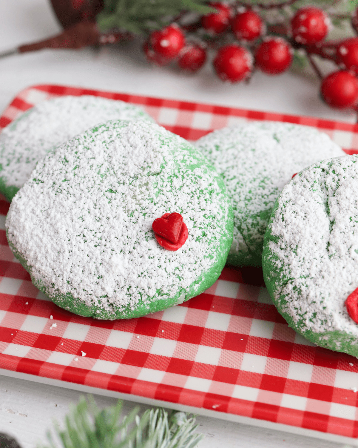 Crispy green sugar cookies with red heart.