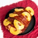 A whole ham with pineapple and brown sugar.
