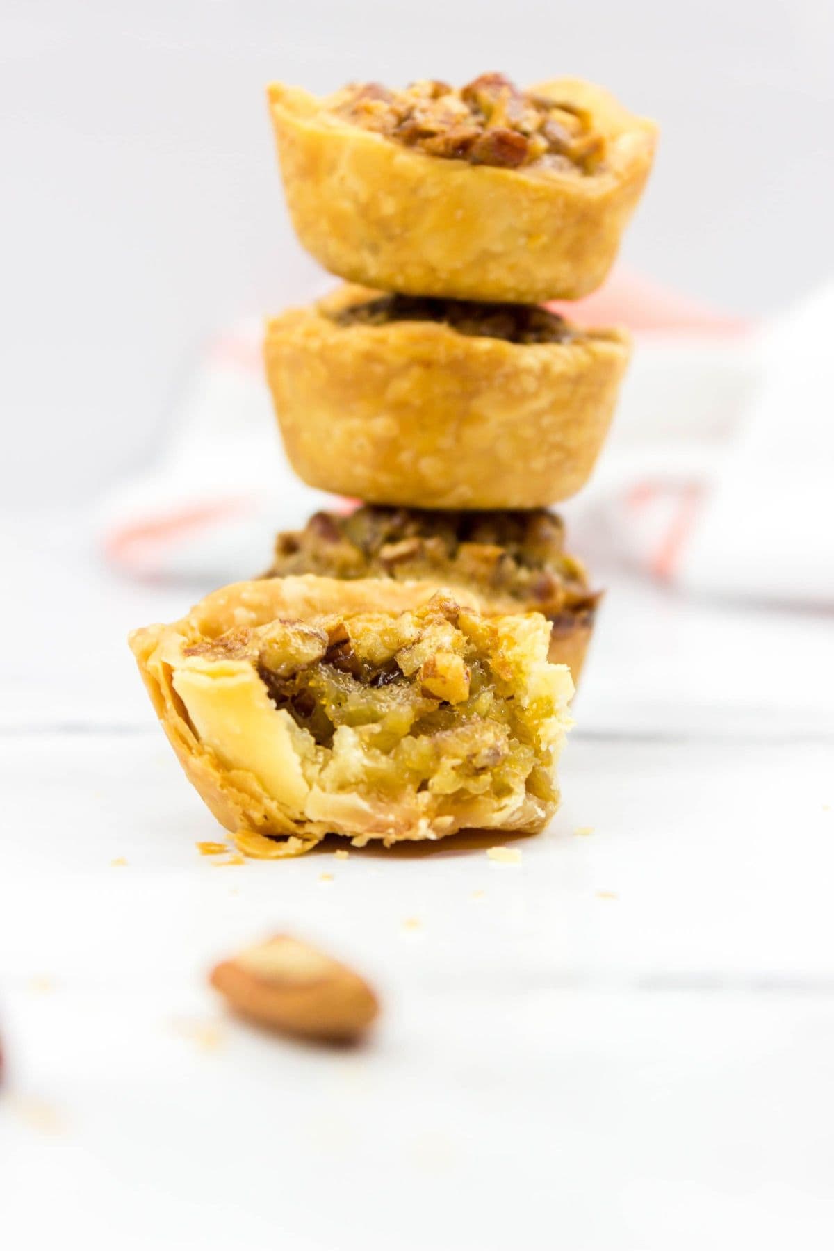 Three stacked, with a fourth in front that is cut open to reveal the rich, gooey filling.