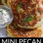 A stack of golden-brown pecan tarts garnished with fresh herbs sits beside a small dish of sour cream. The text overlay reads "MINI PECAN TARTS.