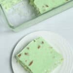 A complete salad in the dish an old fashioned lime cottage cheese salad a slice on a white dish