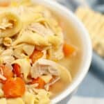 A bowl in front of a striped cloth background.