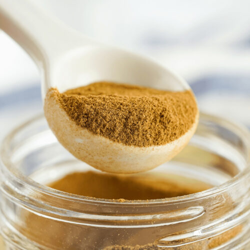 A spoon in the jar of apple pie spice.
