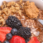 A chocolate cottage cheese breakfast bowl with fresh berries on top.