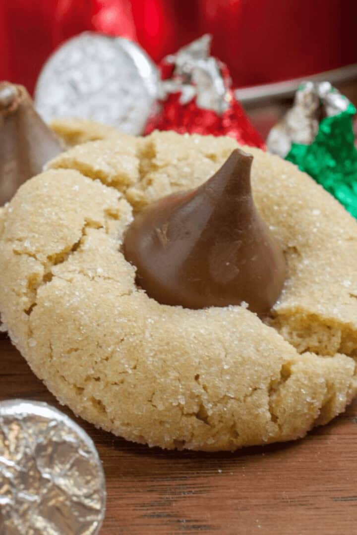 A chocolate kiss cookie surrounded by kiss candies.