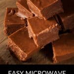 A stack of chocolate fudge squares on a wooden board, with text below reading "Easy Microwave Fudge"—the perfect treat for satisfying your sweet tooth in minutes.