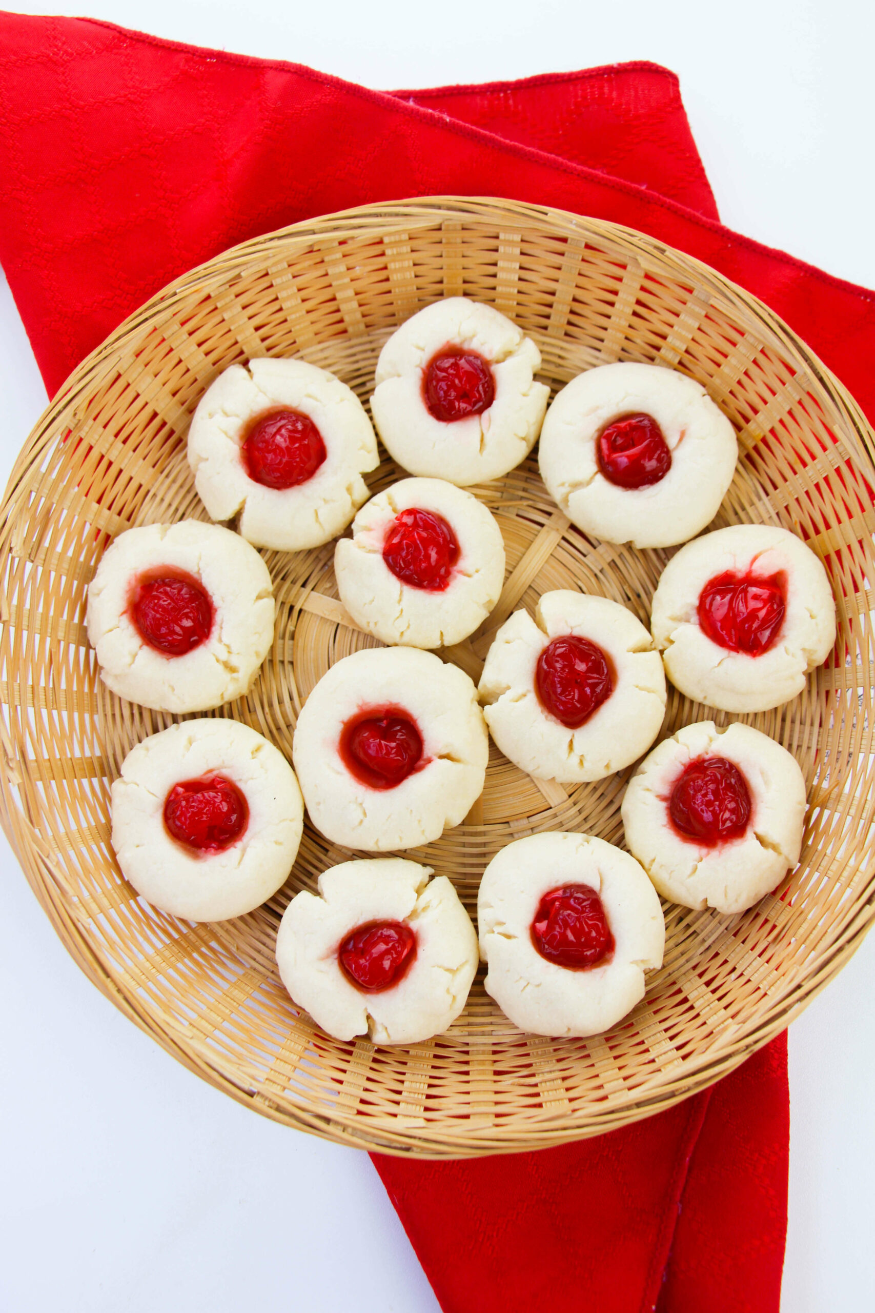 A tray of the cherry cookies with a red napkin.
