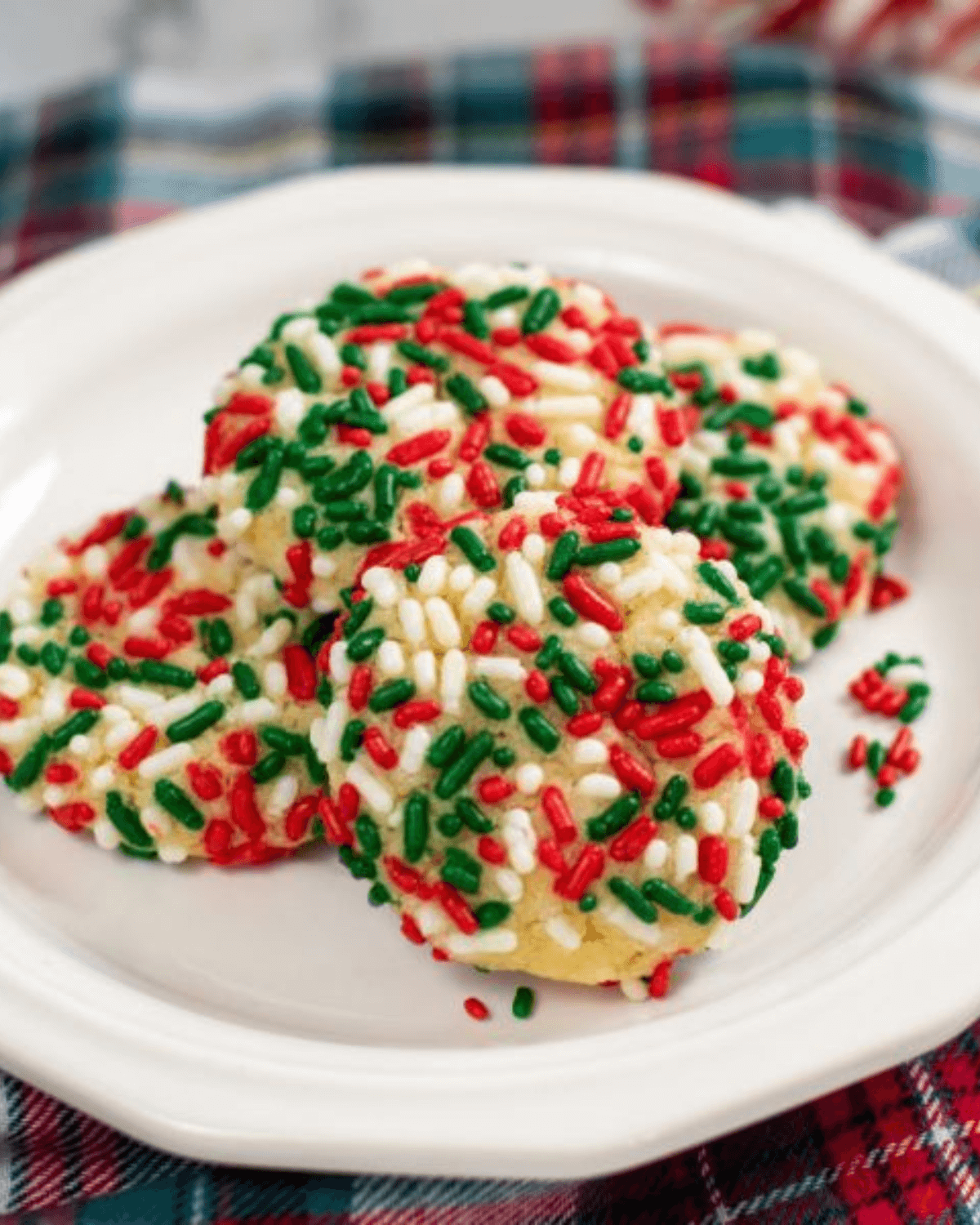 sugar sprinkle cookies on a white plate.