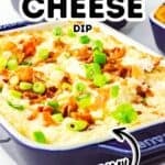 A square baking dish filled with irresistibly creamy baked cheese dip, topped with chopped bacon and green onions, sits on a table near containers of crackers.