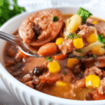 A spoonful with corn, beans, and sausage.