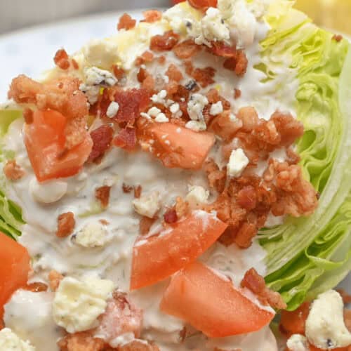 A Wedge Salad Recipe featuring a plate with lettuce, tomatoes, and bacon on it.
