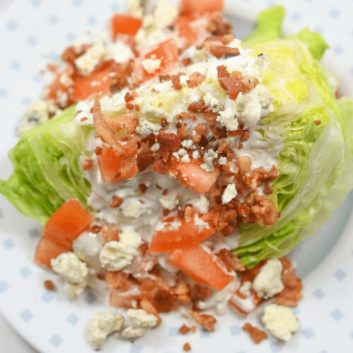 A plate with lettuce, tomatoes, and cheese on it.