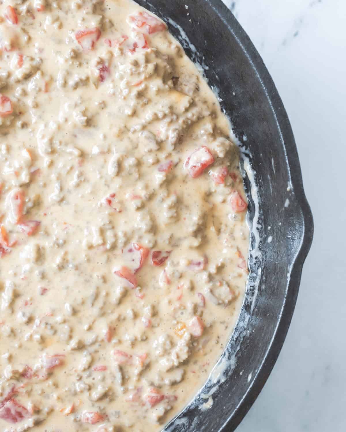 Creamy Velveeta rotel dip in a pan.
