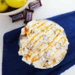 Apple Snickers Salad, a delicious combination of crisp apples, creamy ice cream, and drizzled caramel sauce.