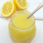 A jar with a spoon next to it.