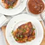 A white plate with sauce on the side.