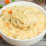 Easy crock pot chicken and dumplings.in a white bowl.