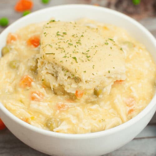Easy crock pot chicken and dumplings.in a white bowl.