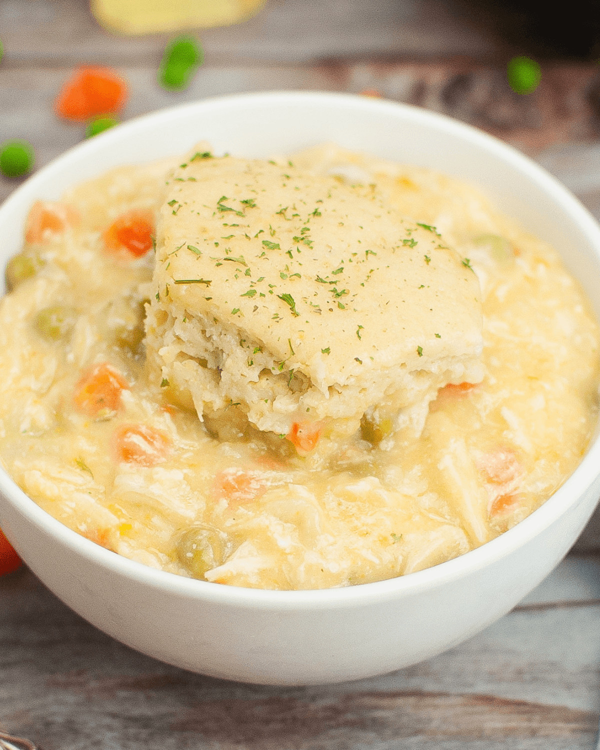 Easy crock pot chicken and dumplings.in a white bowl.