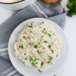 Creamy shrimp risotto topped with fresh parsley and minced garlic.