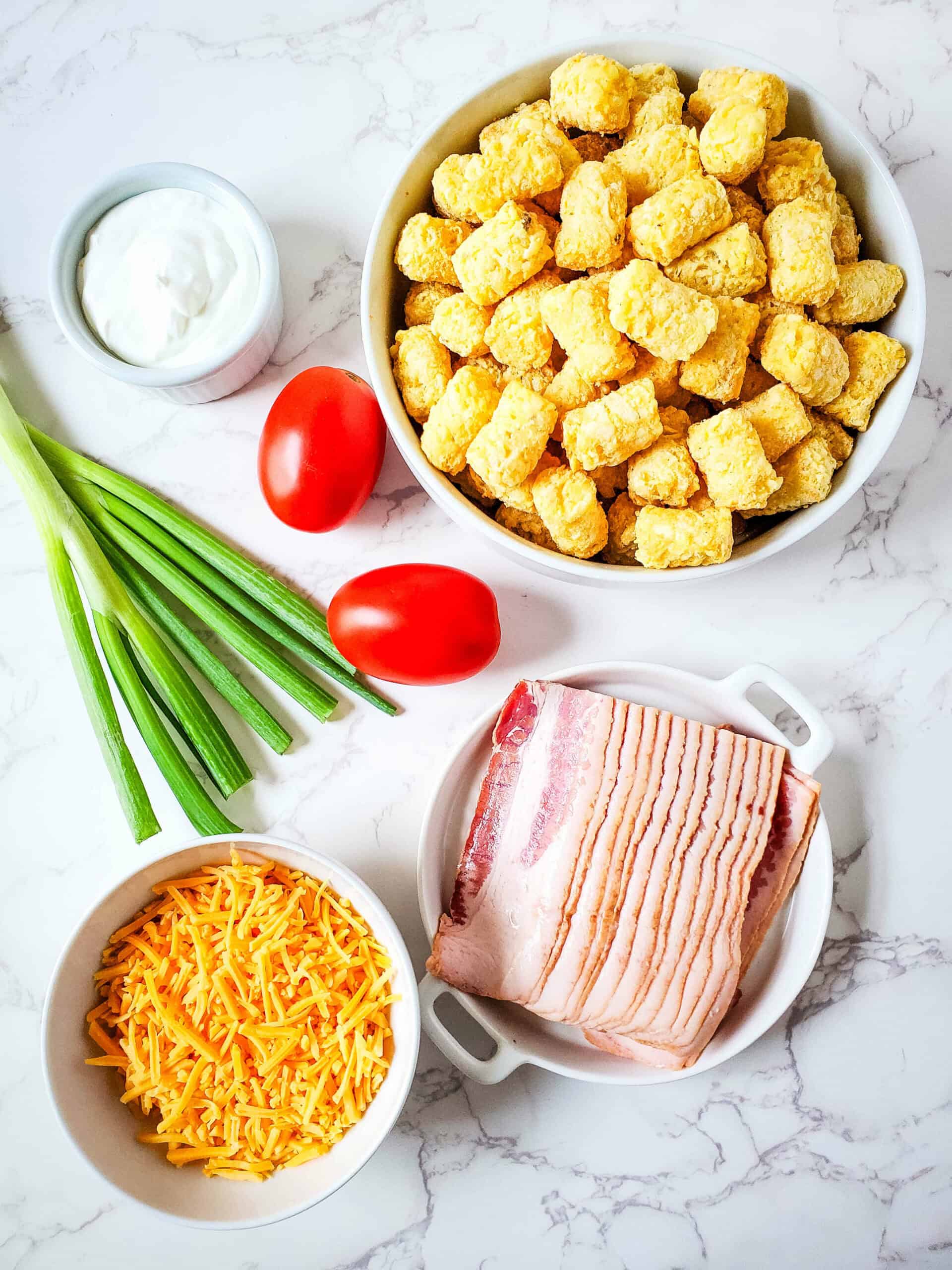 Bacon, onions, potatoes, tomatoes and cheese.