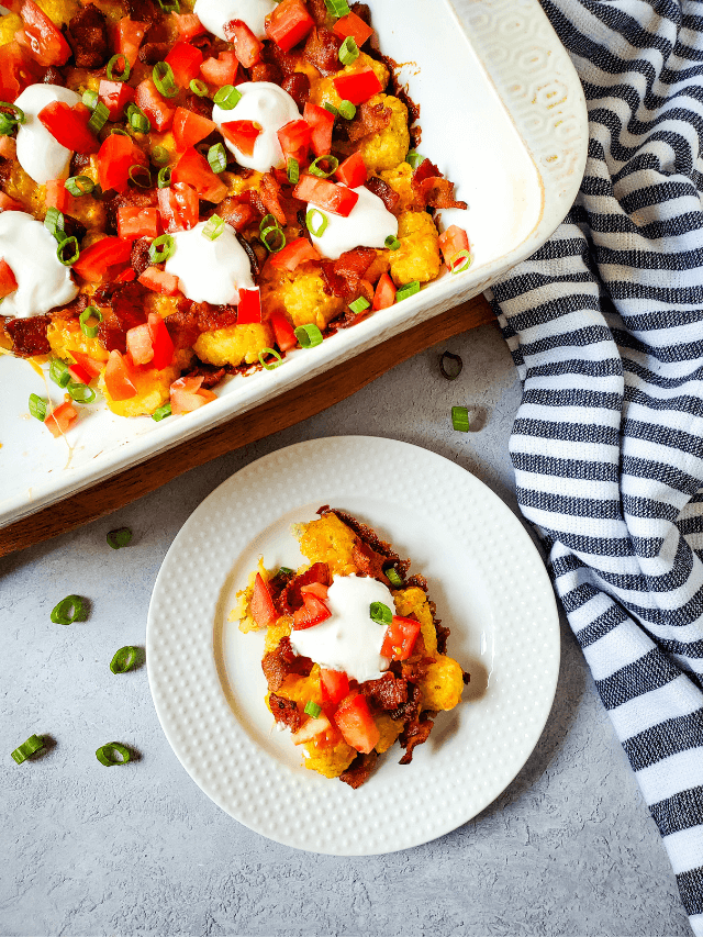A dish with sour cream and tomatoes, like loaded tater tots.