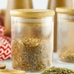 A glass container of the pizza seasoning.