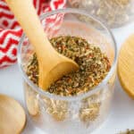 A wooden spoon in the har of spices.