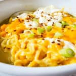 A bowl of cheesy ramen noodles.