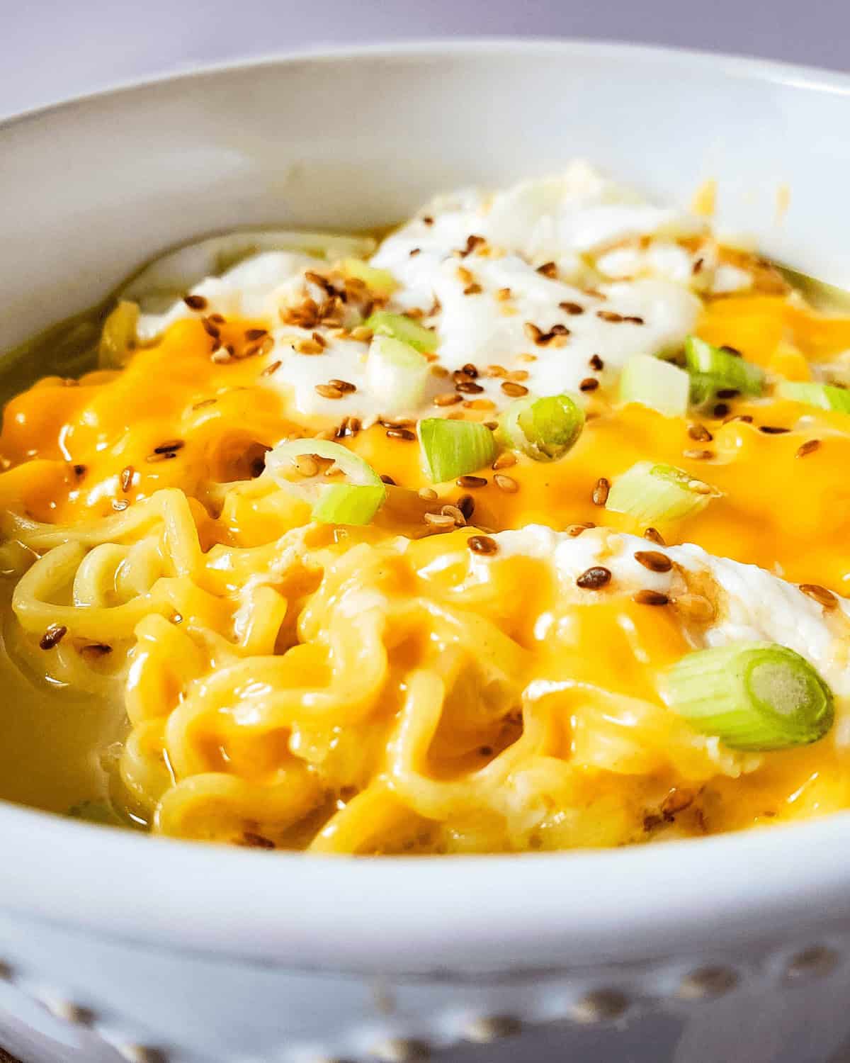 A bowl of cheesy ramen noodles.
