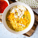 A bowl of the dinner with egg on top.