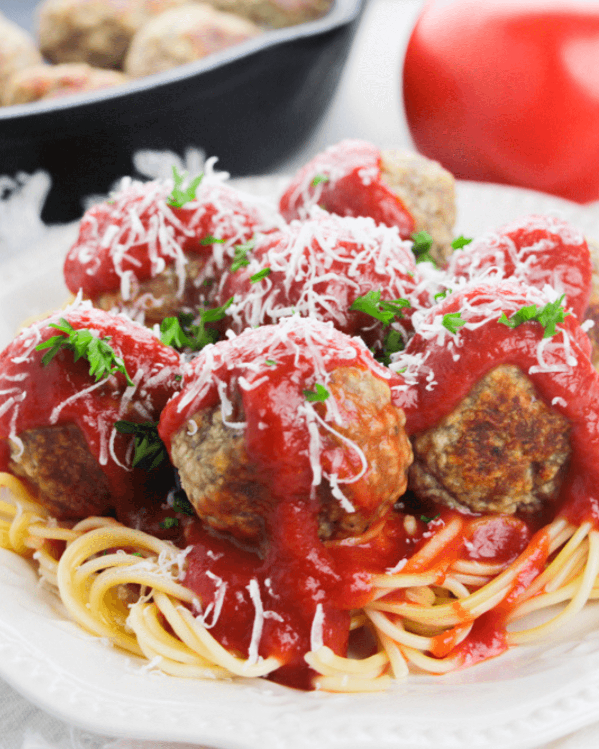 Ricotta meatballs served on a plate with spaghetti and sauce.