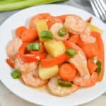 A plate with sheet pan shrimp teriyaki and pineapple.