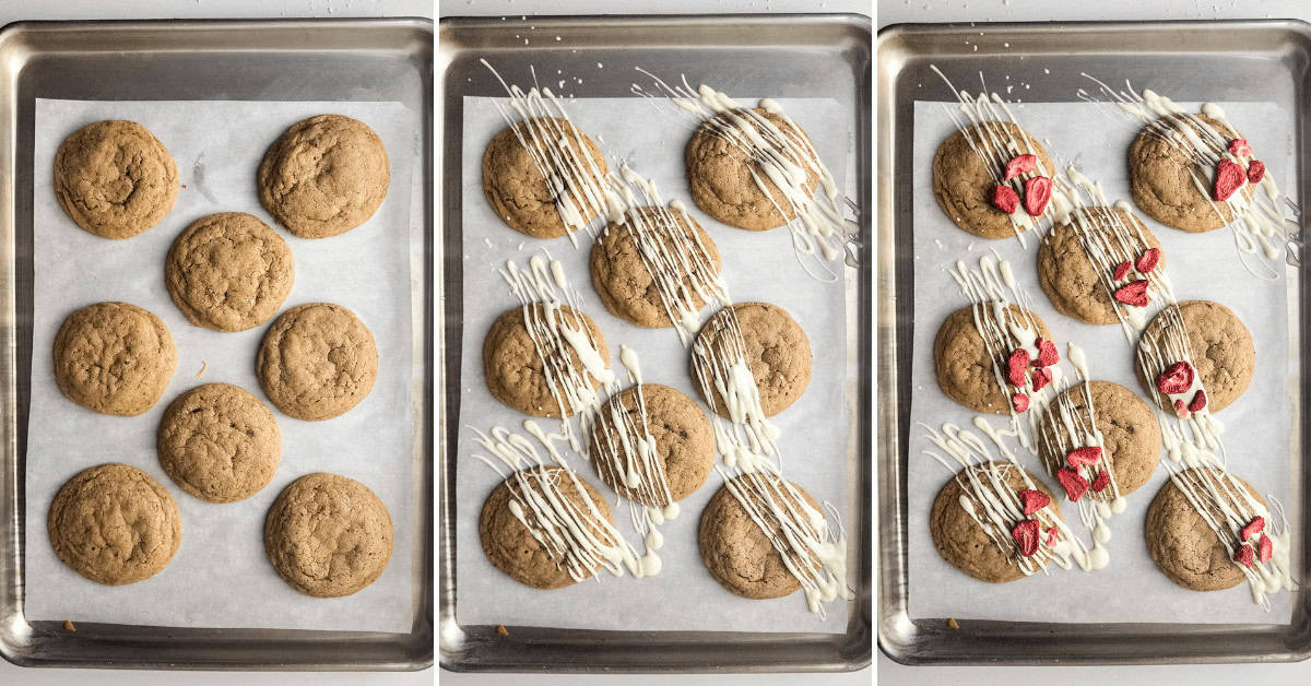 Strawberry cheesecake cookies with frosting on a baking sheet.