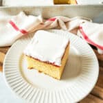A slice of the vanilla raspberry cake on a white plate.