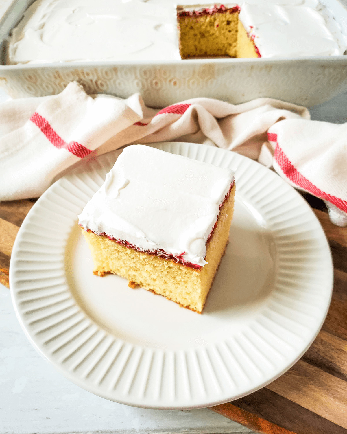 A slice of  the vanilla raspberry cake on a white plate.