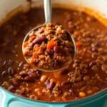 A pot of venison chili with beans and chili seasoning.