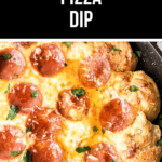 A skillet with melted cheese and pizza dip garnished with herbs.