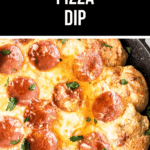 A skillet with melted cheese and pizza dip garnished with herbs.