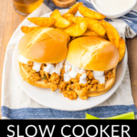 Plate with slow cooker buffalo chicken sloppy joes served with a side of fries and a dipping sauce, accompanied by a beverage.