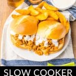 Plate with slow cooker buffalo chicken sloppy joes served with a side of fries and a dipping sauce, accompanied by a beverage.