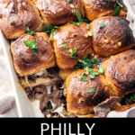 A tray of steak and cheese sliders garnished with parsley.