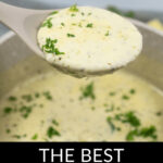 A ladle scooping creamy garlic parmesan sauce sprinkled with parsley, with a pot of the same garlic parmesan sauce blurred in the background.