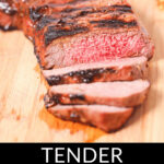 Slices of tender grilled London broil on a cutting board, with charred marks visible and a lemon half in the background. The text overlay reads "grilled London broil.