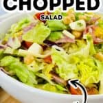 A bowl of Italian Chopped Salad with crisp lettuce, juicy tomatoes, hearty chickpeas, cheese, and savory sliced meats. Text on the image reads “Italian Chopped Salad” with a bold “viral” label.
