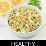 A bowl of quinoa and chickpea salad garnished with lemon slices and mint leaves, labeled as "Jennifer Aniston salad.