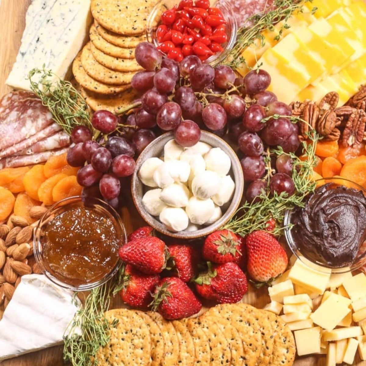 A recipe index featuring a charcuterie board with an assortment of cheeses, cured meats, nuts, fruits, crackers, and dips, arranged decoratively.