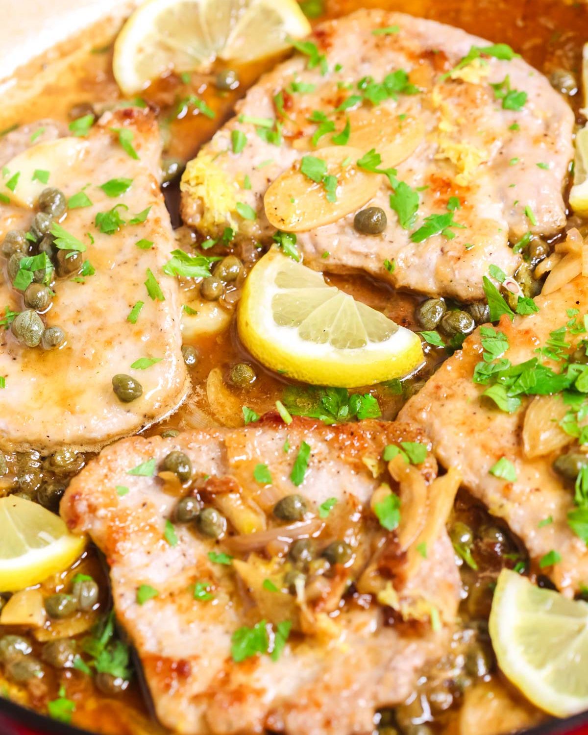 Thin sliced pork in piccata sauce with lemons and parsley. 