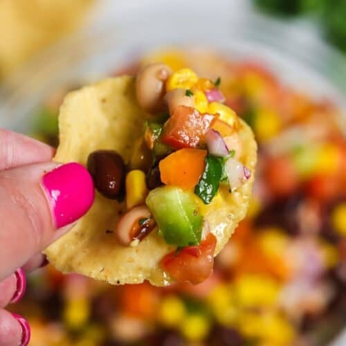A hand holding a chip with the easy redneck caviar.